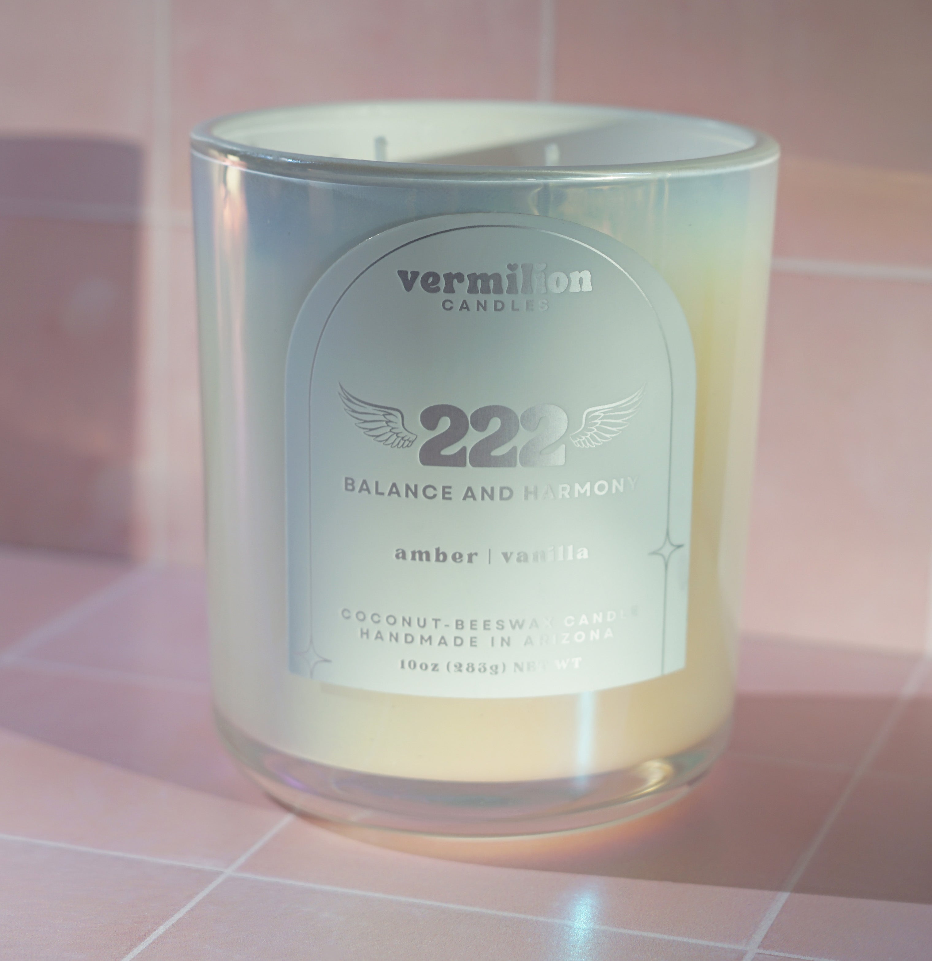 Vermilion Candle labeled '222 Balance and Harmony' on a pink tiled background